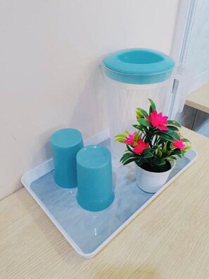 A bathroom with a toilet paper holder, a trash bin, and a potted plant. - Abc Hostel By Zuzu (Seri Kembangan)