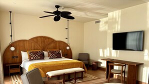 A hotel room with a large bed, a desk, a chair, a TV, and a ceiling fan. - Punta Bermeja Premium Beach Hotel (El Puerto de Santa Maria)
