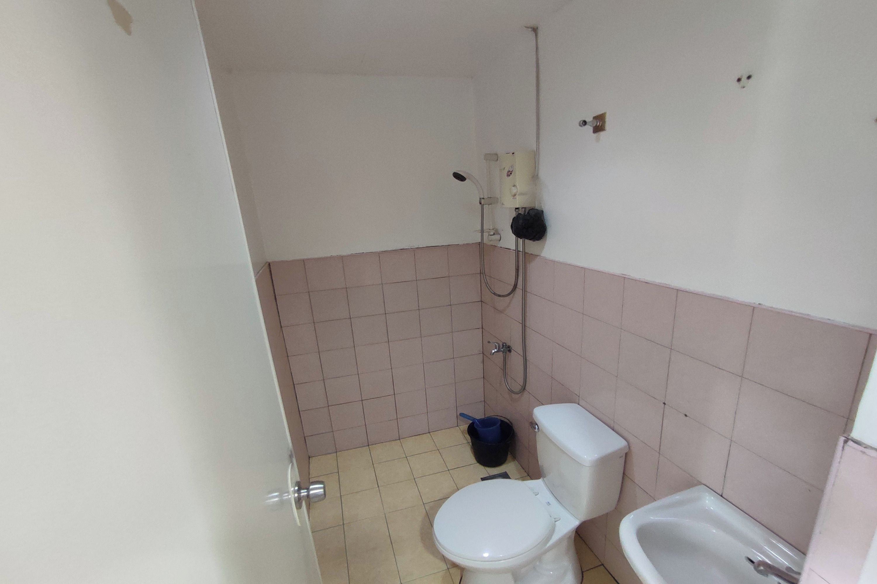 A small bathroom with a toilet, a bidet, and a shower.
