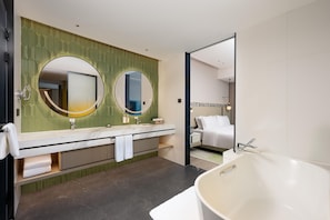 A modern bathroom with a large bathtub, two sinks with mirrors, a vanity with a towel rack, and a green patterned wall. - Holiday Inn Fuzhou Exhibition Center (Fuzhou)