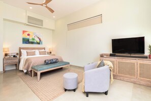 A modern bedroom with a bed, bedside table, lamp, TV, and a bench. - Ayuda Sanctuary Boutique Negombo (Negombo)
