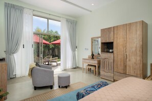 A bedroom with a bed, a wooden wardrobe, a desk with a chair, and a sofa. - Ayuda Sanctuary Boutique Negombo (Negombo)