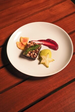 A white plate with a dessert on a wooden table. - Ayuda Sanctuary Boutique Negombo (Negombo)