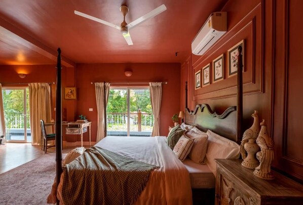A bedroom with a bed, a desk, a chair, a ceiling fan, and a window with curtains. - Elivaas Bludoor - Goa (Assagao)