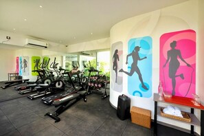 A gym with treadmills, stationary bikes, and dumbbells. - The Orchid Passaros (Benaulim)