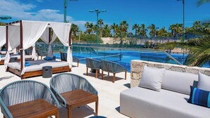 A poolside area with a canopy bed, lounge chairs, and a sofa. - Bohari (San José del Cabo)