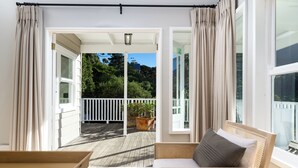 A balcony with a wooden floor, white railings, and a potted plant. - Bay Haven Collection, Hout Bay (Cape Town)