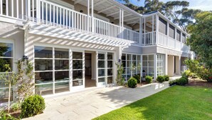 A two-story house with a balcony, large windows, and a well-maintained lawn. - Bay Haven Collection, Hout Bay (Cape Town)