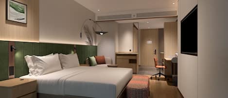 A modern hotel room with a large bed, a desk, and a TV.