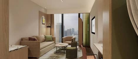A modern living room with a sofa, armchair, coffee table, and a desk with a chair.