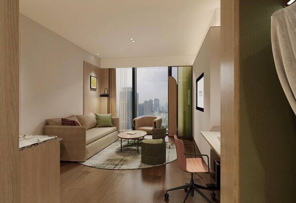 Una sala de estar moderna con sofá, sillón, mesa de centro y escritorio con silla.
