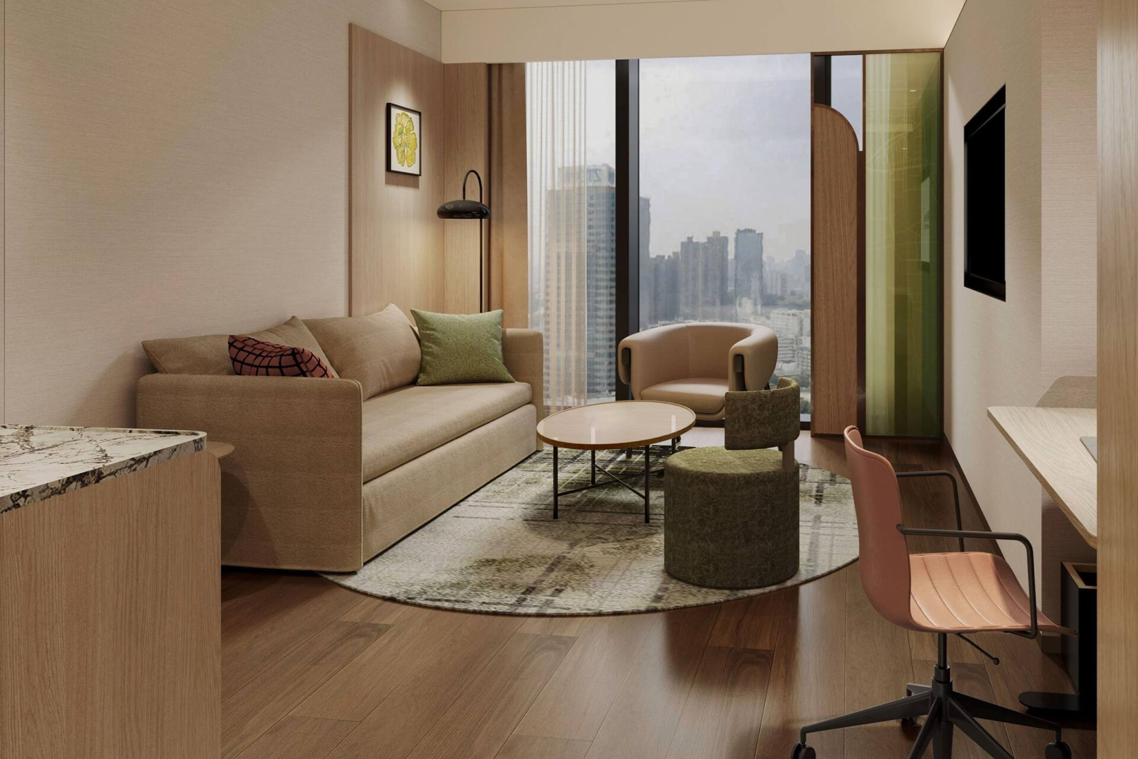 A modern living room with a sofa, coffee table, and chairs, a desk, and a large window with a city view.