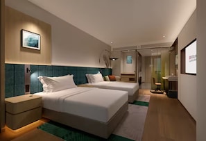 A modern hotel room with two beds, a desk, and a chair.