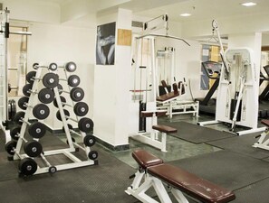 A gym with weightlifting equipment, benches, and exercise machines. - Ira By Orchid Mumbai - T2 International Airport (Mumbai)