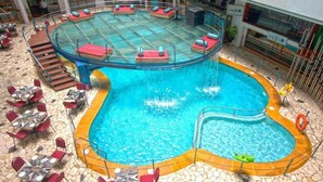 A pool area with a circular hot tub, lounge chairs, and tables. - Ira By Orchid Mumbai - T2 International Airport (Mumbai)