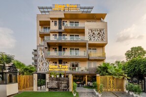 A multi-story hotel with a sign reading "Time Tree Hotel & Service Apartments." - Lime Tree Hotel - Near Medanta Hospital (Gurugram)