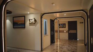 A hotel corridor with a sign indicating room number 2001-2014 on the 1st floor.