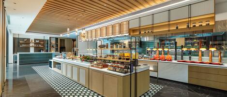 A modern kitchen area with a central island, wooden ceiling, and tiled flooring.