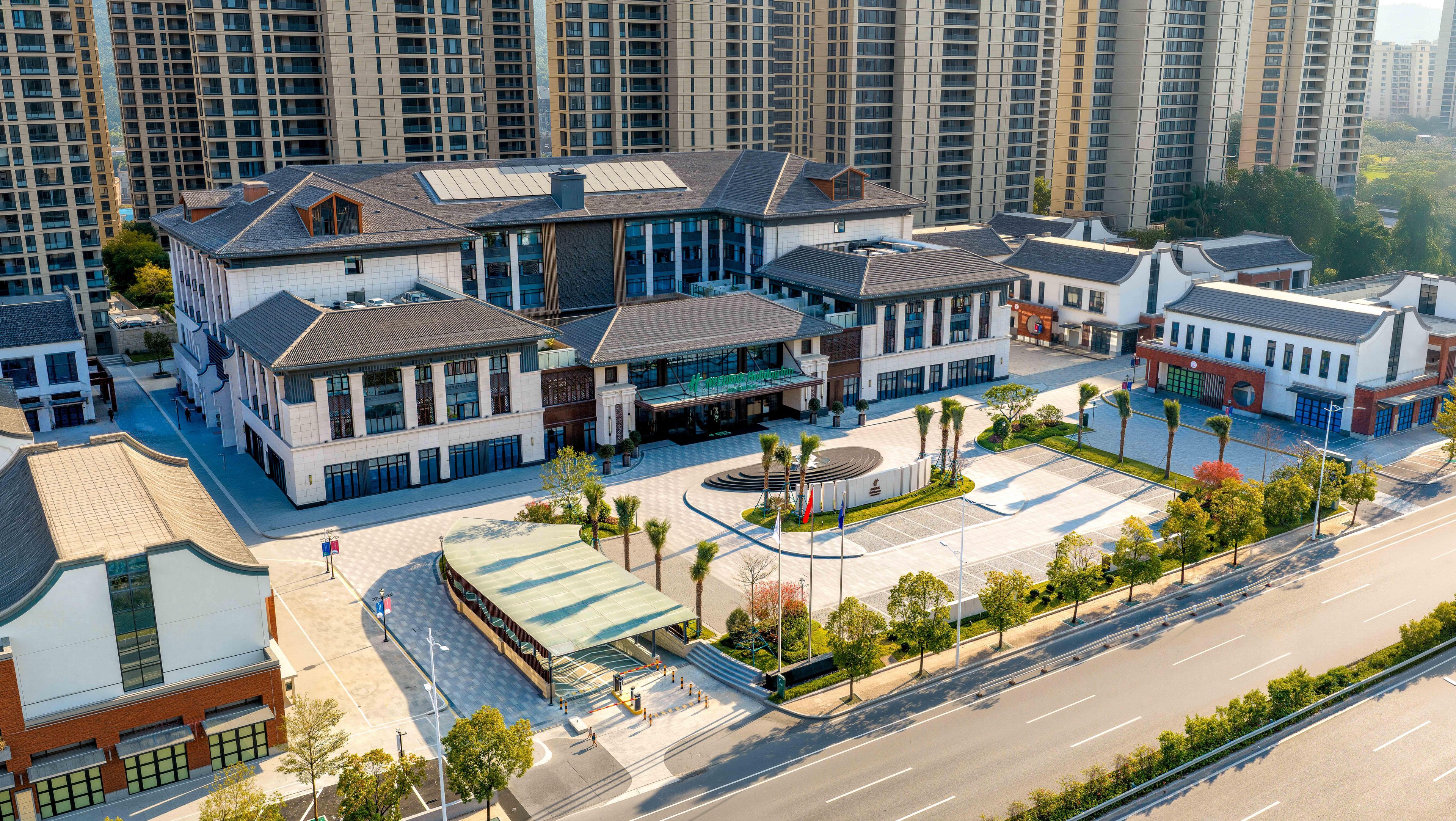 A modern hotel with a central courtyard, surrounded by high-rise buildings.
