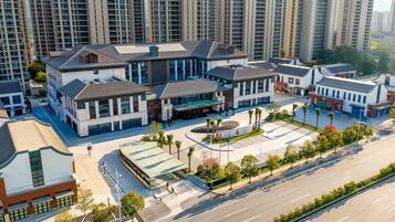 A modern hotel with a central courtyard, surrounded by high-rise buildings.