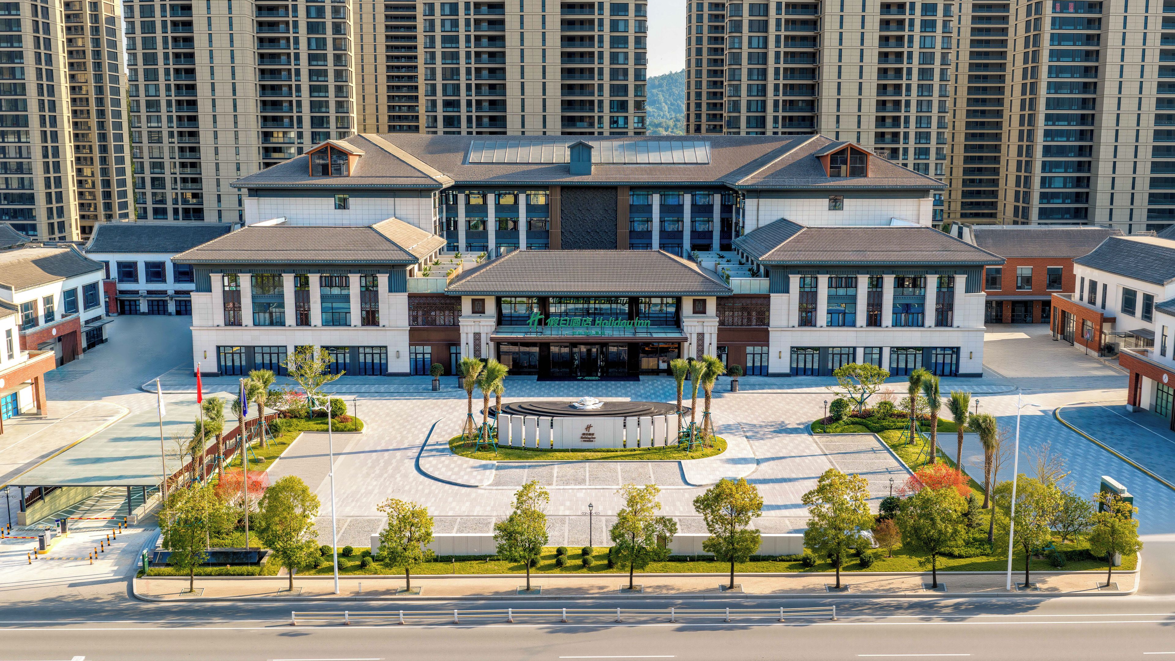 A modern hotel with a central courtyard, multiple wings, and a prominent entrance.