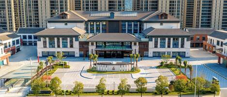 A modern hotel with a central courtyard, multiple wings, and a prominent entrance.