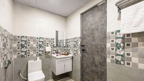 A bathroom with a toilet, sink, and shower. - Alaya Stays By Elivaas Lake City Heights (Udaipur)