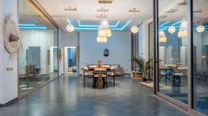 A modern interior with a dining area, large windows, and contemporary lighting fixtures. - Life Resort (Marrakech)