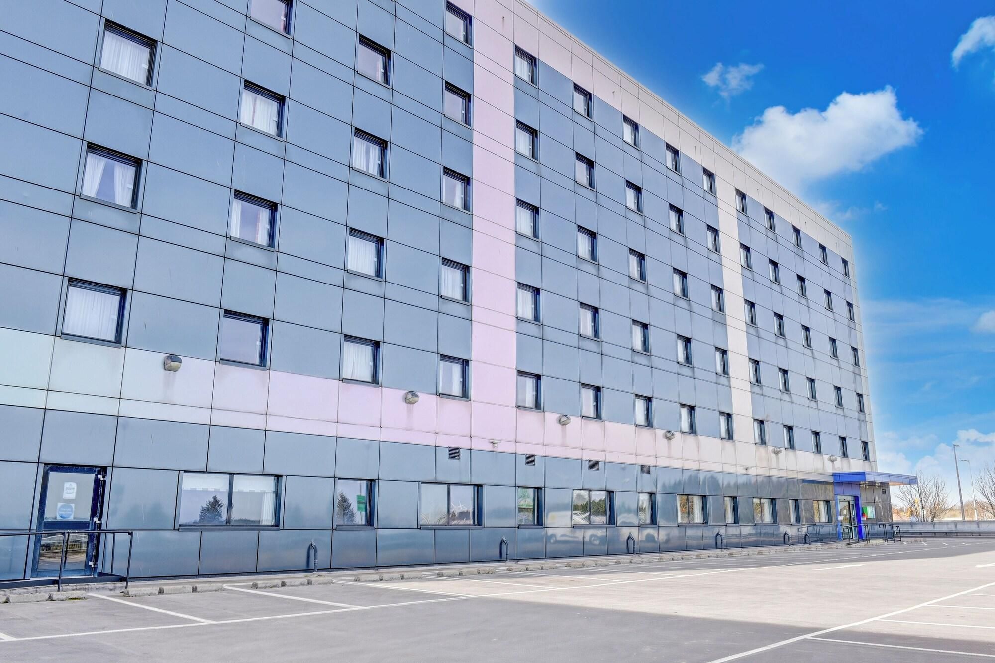 A modern building with a grid of windows and a flat facade.