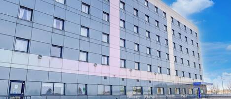 A modern building with a grid of windows and a flat facade.