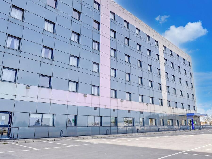 A modern building with a grid of windows and a flat facade.
