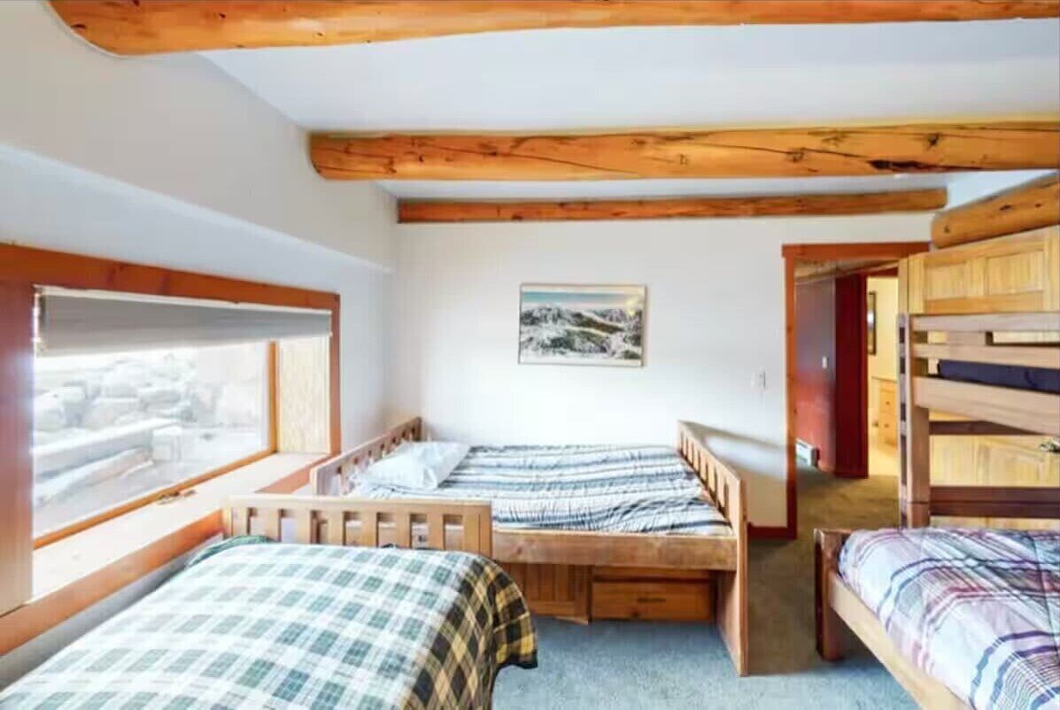 Bedroom 4: 2 bunk beds (full/twin + twin/twin), 1 Twin bed, lower floor, dresser drawers, carpet flooring