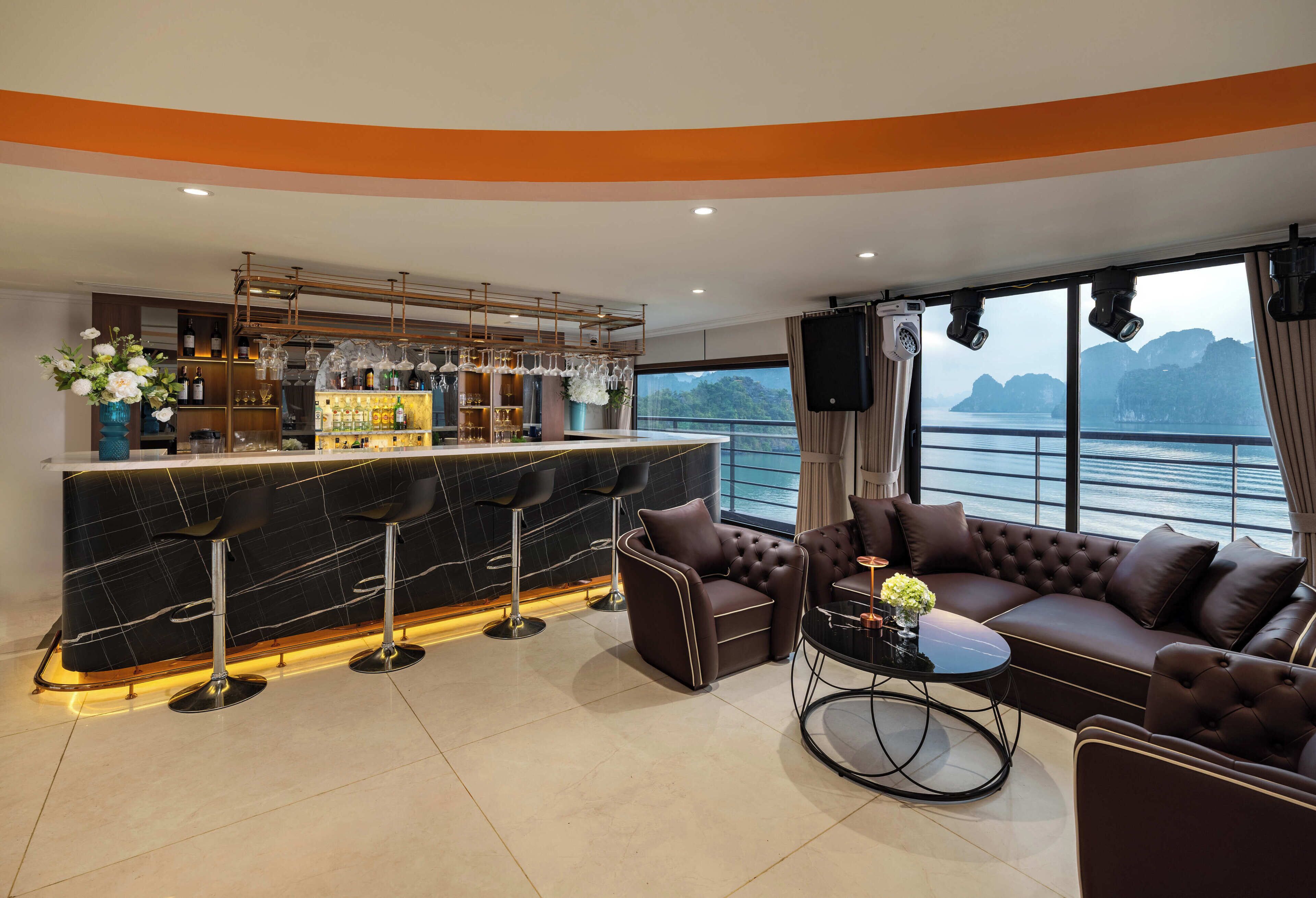 A modern bar area with stools, a sofa, and a round coffee table.