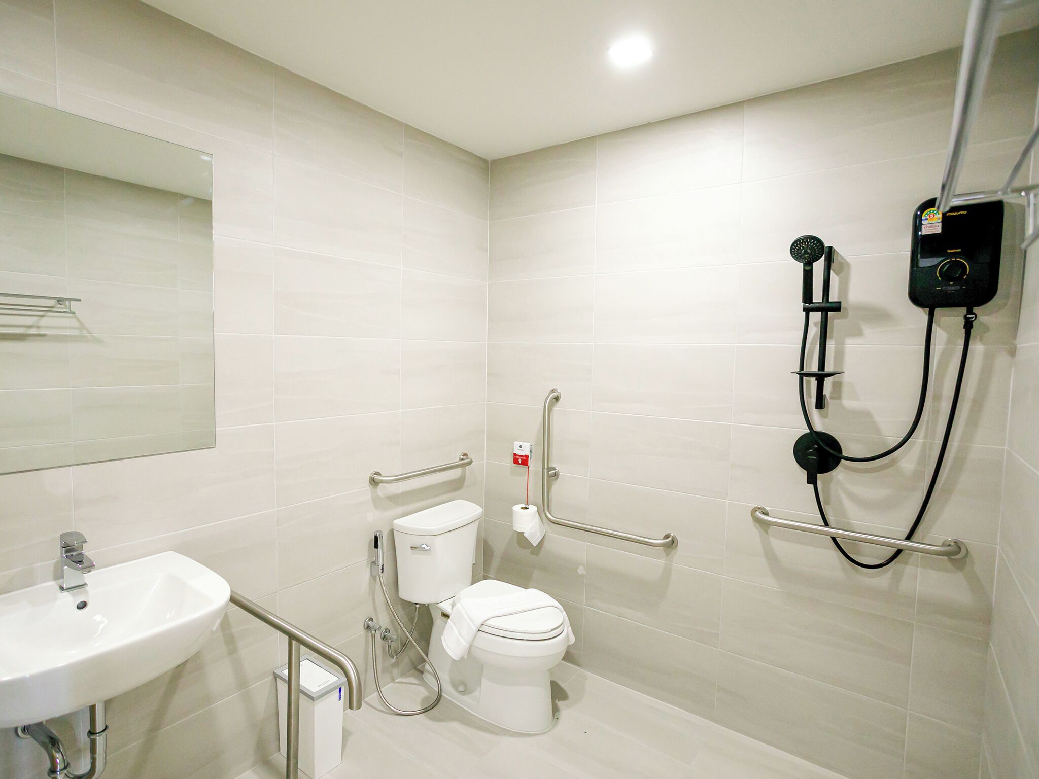 A modern bathroom with a white sink, toilet, and shower.