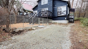 A rustic cabin with a wooden deck and a gravel path leading to the entrance. - rinne 2nd living Nasu Garden (Nasu)