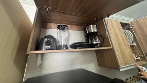 A kitchen with wooden cabinetry and a countertop.