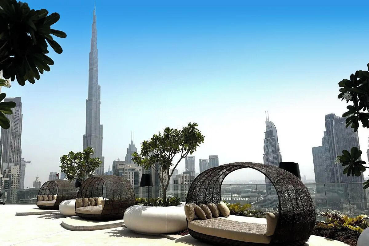 A rooftop lounge with modern seating and a view of the Burj Khalifa.