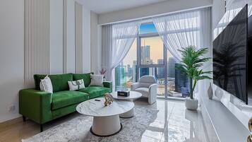 Premium Apartment, City View | Living room | 65-inch Smart TV with cable channels