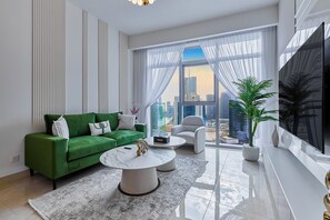 Premium Apartment, City View | Living room | 65-inch Smart TV with cable channels