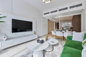 Premium Apartment, City View | Living room | 65-inch Smart TV with cable channels