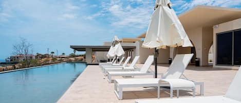 Outdoor pool, pool umbrellas, sun loungers