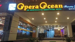 The exterior of the Opera Ocean hotel with a sign indicating it is an aristocratic residential hotel. - Hotel Opera Ocean (Cox's Bazar)