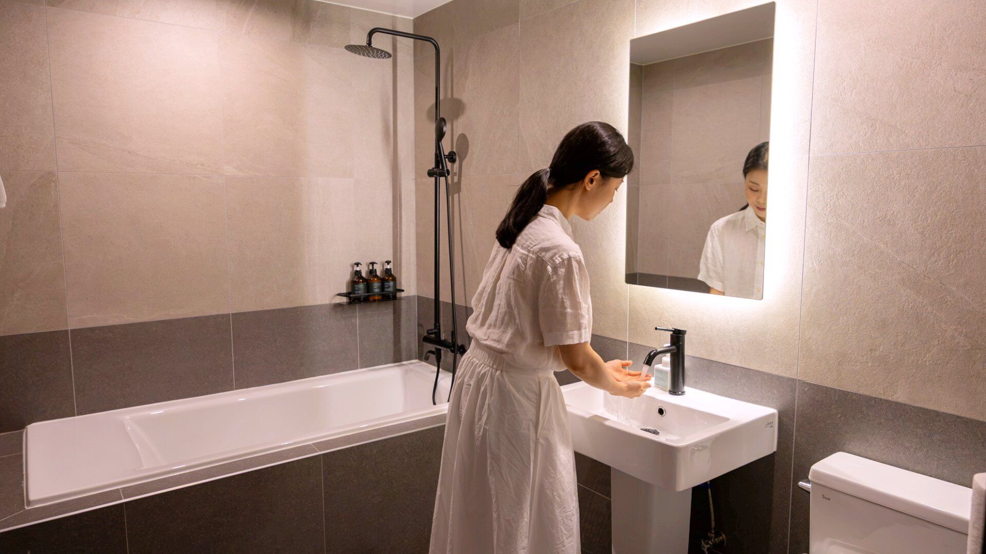 A bathroom with a bathtub, a sink, and a toilet.