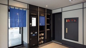 A self-service area with card decks, a self check-in station, and a staff only door. - Mitasuya Ryokan Hotel by Anook Daejeon Yuseong (Daejeon)