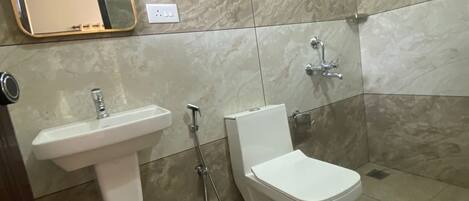 A modern bathroom with a sink, toilet, and shower.