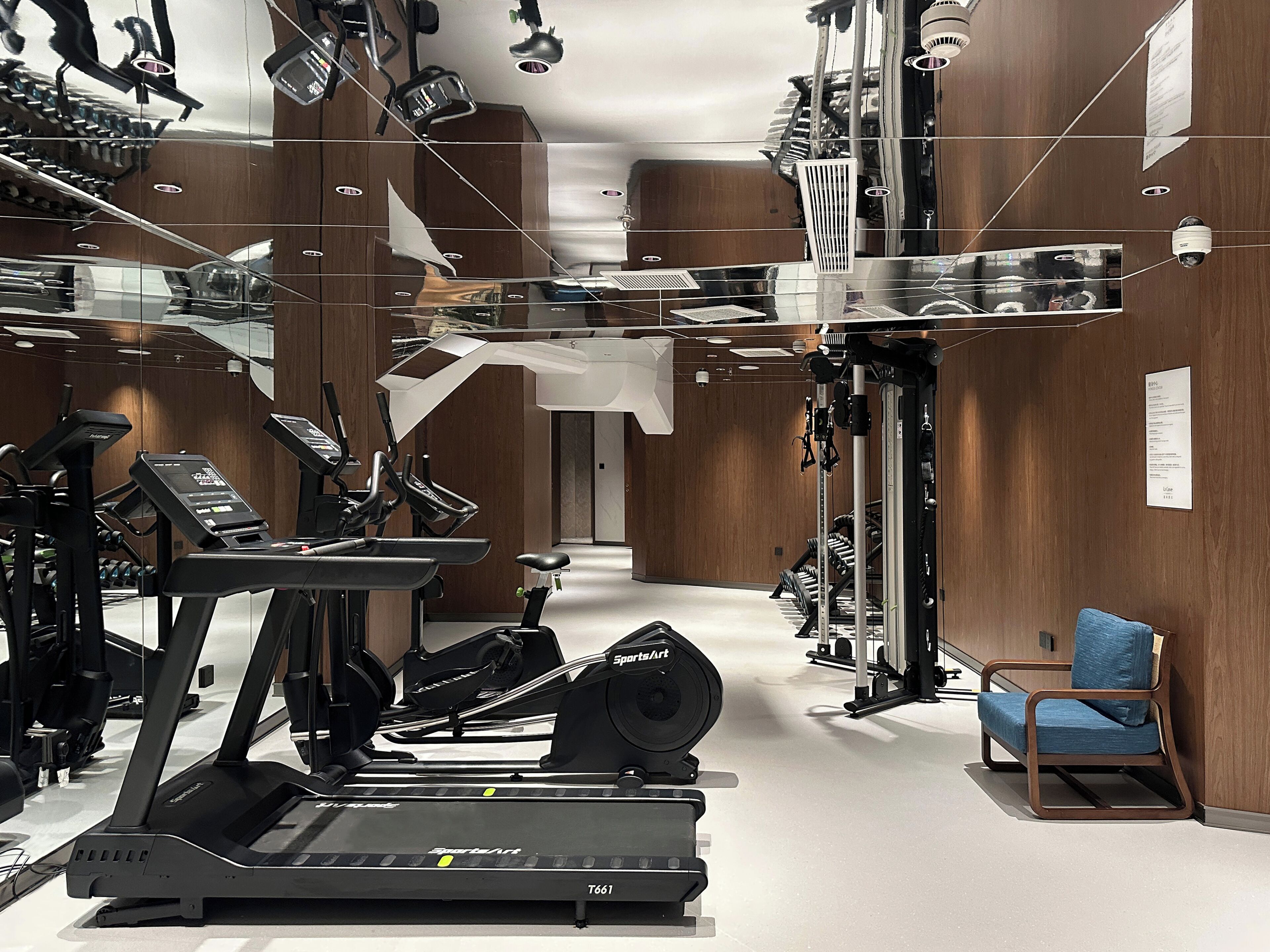A gym with treadmills, exercise bikes, and weight machines.