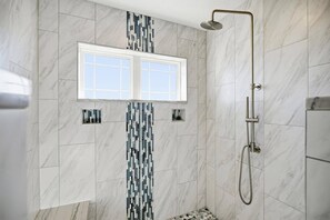Shower, hair dryer, towels, shampoo