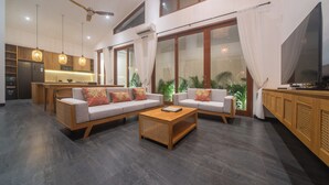 A modern living area with a sofa set, a coffee table, and a TV. - Brand New 3Bedroom Lucky Lotus Villa Private Pool (Bali)