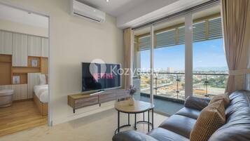 Apartment, 2 Bedrooms, City View | Living area | 50-inch Smart TV with cable channels, Netflix, streaming services