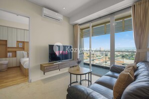 Apartment, 2 Bedrooms, City View | Living area | 50-inch Smart TV with cable channels, Netflix, streaming services